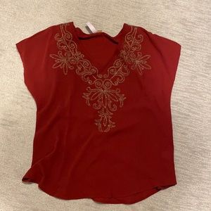 Dark red blouse with detailing.